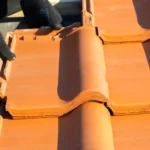 Installing terracotta roof tiles on a house