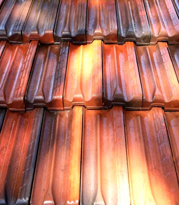 Red clay roof tiles with sunlight reflections